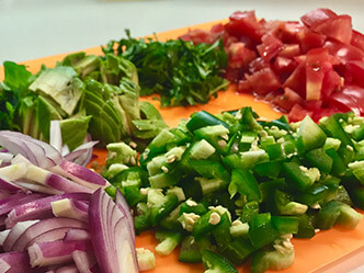 Image of chopped vegetables including onions peppers and tomatoes