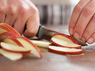 Image of person slicing an apple